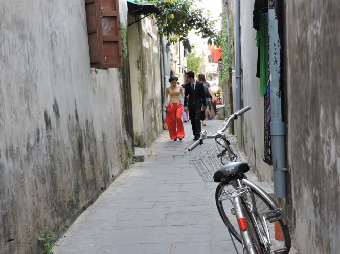 A couple is seen walking in a small alley in Hoi An Ancient Town. Photo: Tuoi Tre